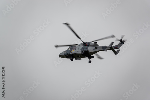 Fototapeta Naklejka Na Ścianę i Meble -  British army AgustaWestland AW159 Wildcat AH1 helicopter flying on military training exercises, Wiltshire UK
