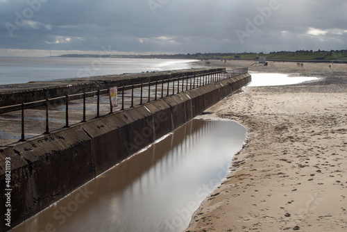Sea defences wall barrier with views looking towards the beach at Gorleston-on-sea in Norfolk  UK