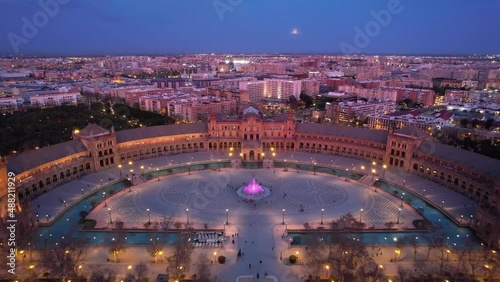 night view of Plaza de Espana in Seville, aerial view with night lights, famous Seville landmark after sunset, downtown Seville at night, drone shot of Seville skyline