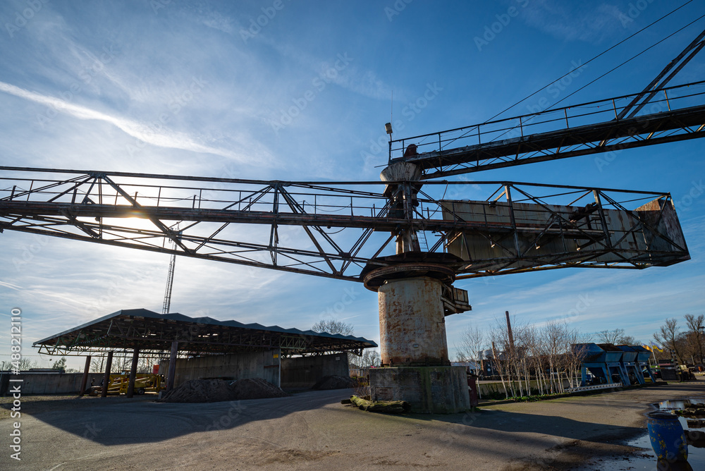 Machinery of an old asphalt plant near river Hollandsche IJssel in Gouda, Netherlands
