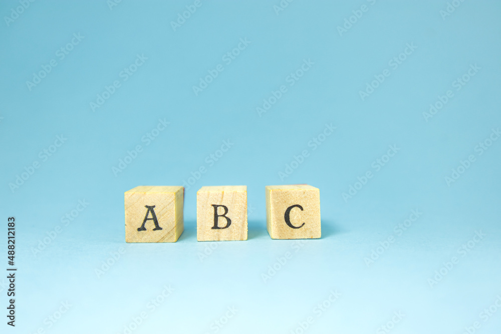 A B C alphabet tiles on blue background. A B C alphabet tiles on blue background.