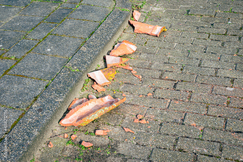Roof tiles have been blown off a roof during a severe storm and broken on the street photo