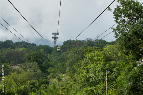 Suspended cable car to the mountain peaks covered with clouds