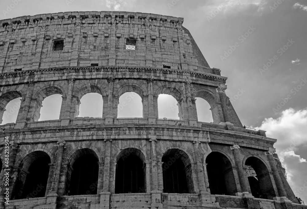 Black and white closeup of a section of the Colosseum in Rome.