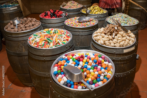 Barrels of colorful candy and sweets in a shop.