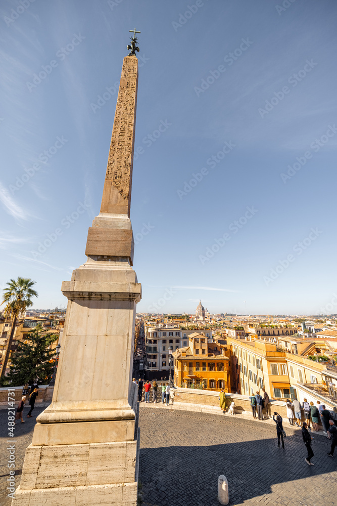 Cityscape view from the top of Spanish stairs with Sallustiano obelisk in Rome on a sunny day. Traveling Italy concept. Idea of visiting famous italian landmarks