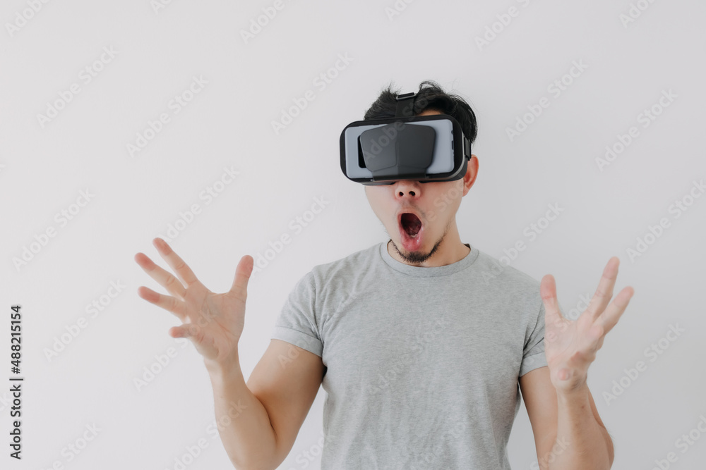 Wow surprised face of Asian man wears virtual glasses for metaverse technology. Wow surprised face of Asian man wears virtual glasses for metaverse technology.