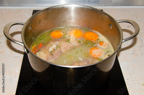 cooking broth from pork knuckle with vegetables. Preparation for jelly from pork meat