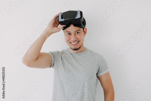 Happy Asian man present virtual glasses application for metaverse technology.