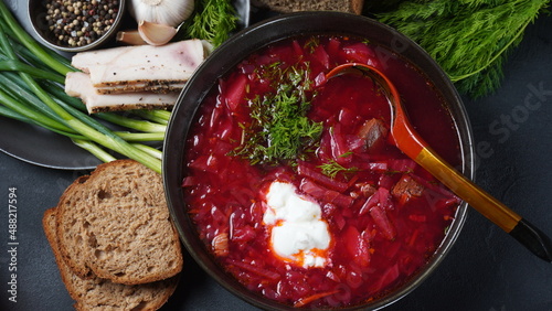 Traditional Ukrainian Russian borscht . Bowl of red beet root soup borsch with white cream . Beet Root delicious soup . Traditional Ukraine food cuisine