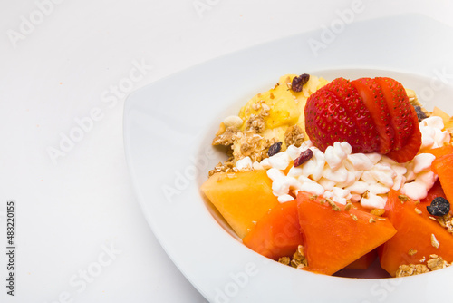 Plate of nutritious fruits for breakfast on white background