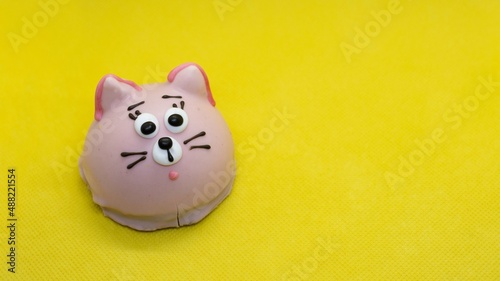 chocolate cookies with cream. yellow background. cat
