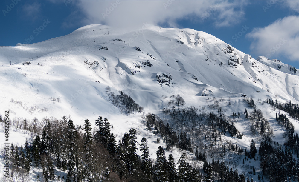 Panoramic view of south slopes and Kamenny stolb mountain in Rosa Khutor ski resort. Krasnya Polyana, Russia