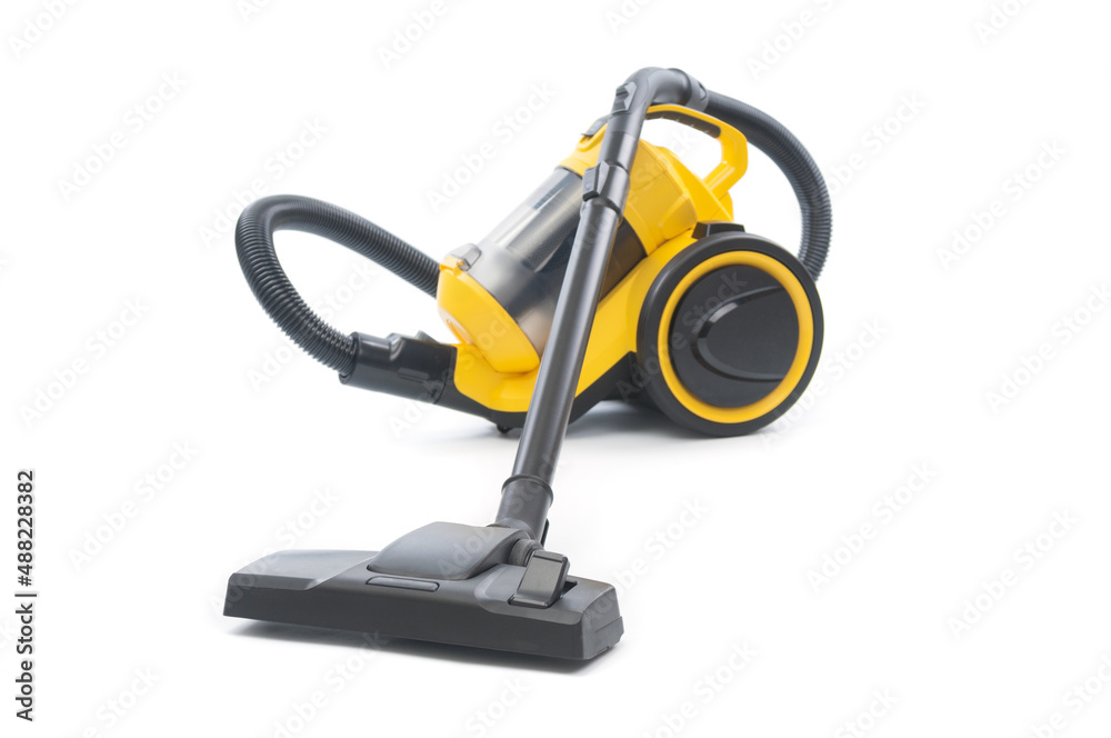 Yellow vacuum cleaner with sweeping brush isolated on white background. Front focus Yellow vacuum cleaner with sweeping brush isolated on white background. Front focus