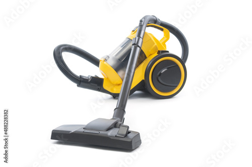 Yellow vacuum cleaner with sweeping brush isolated on white background. Front focus