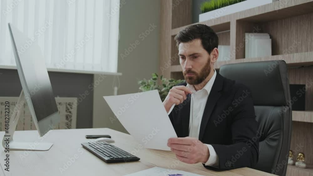 Businessman reading business contract, planning project, working in office, reading resume, analyzing documents, recruiting process Businessman reading business contract, planning project, working in office, reading resume, analyzing documents, recruiting process