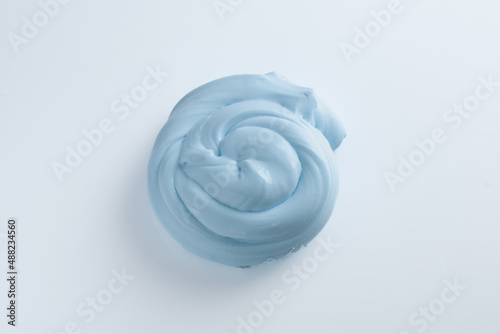 blue slime rolled into a pretzel on a white background © Pavel