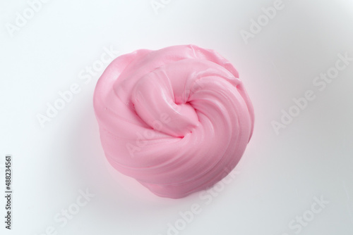 pink slime rolled into a pretzel on a white background