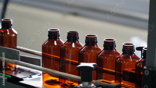 many bottles for bottling medicines. many small open brown glass oval pharmacy bottles close up