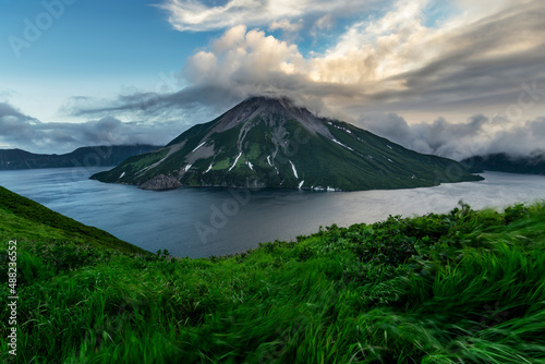 Untouched pristine nature of Onekotan Island, small volcanic island in the Sea of Okhotsk, part of Kuril chain of islands. Krenitsyn volcano is in the center of caldera lake.