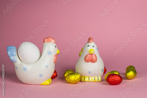 two chickens and chocolate eggs background for Easter © Міша Мула