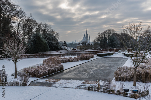 Panoramic view over the Stuyvenberg city park with frozen ponds, snowy reeds and meadows, Laeken, Belgium photo