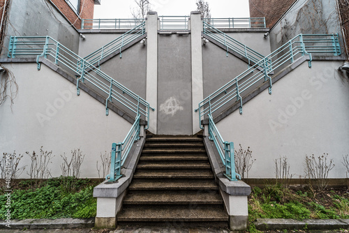 Schaerbeek, Brussels / Belgium - The symmetric diagonal staircase of the dead end Auguste Snieder street with a view on traditional residential houses photo