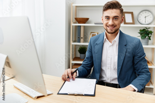 businessmen writes in documents at the desk in the office executive