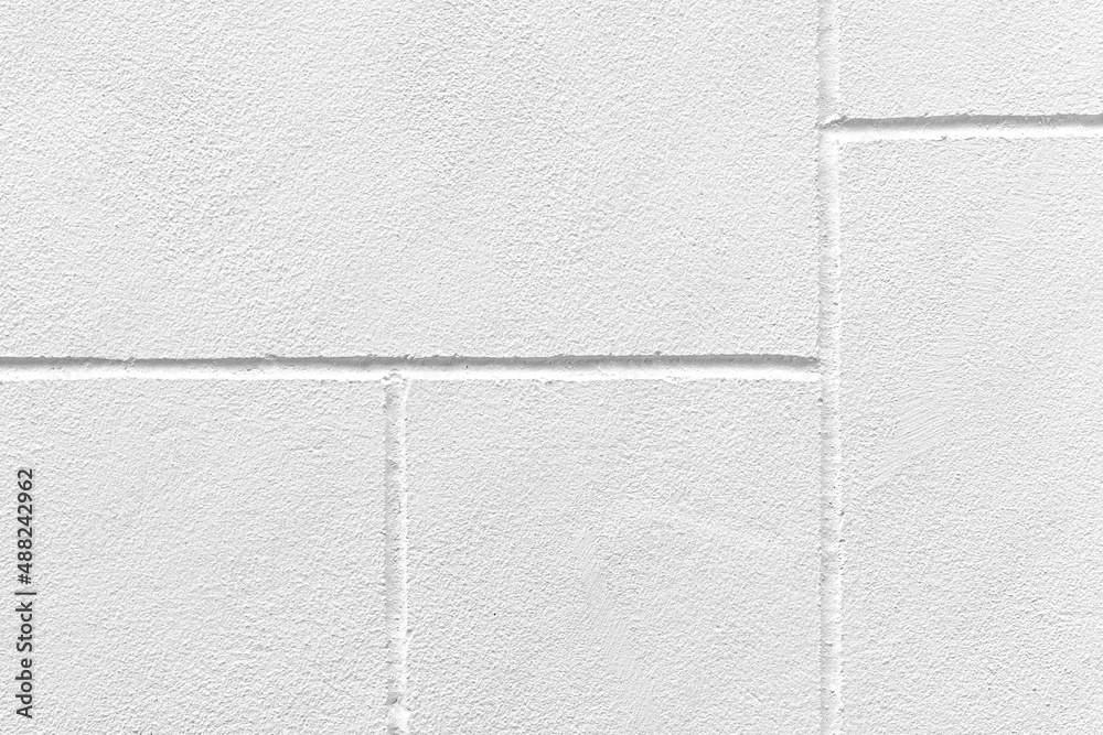 Fototapeta premium The walls of the cement building are painted white with a rough surface
