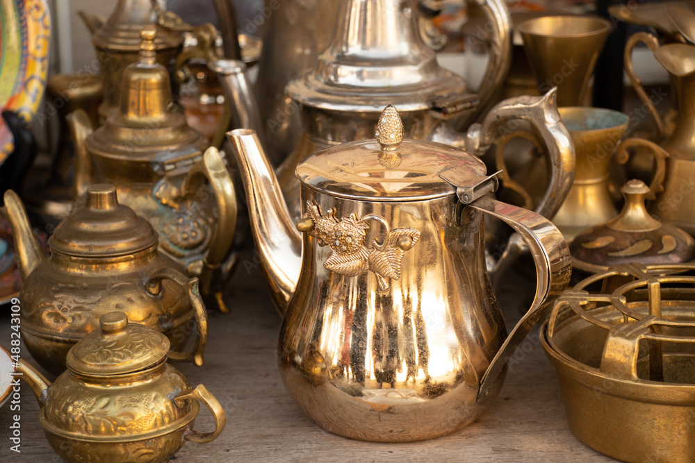 Copper antique jugs on the shelves, a collection of antique copper utensils Copper antique jugs on the shelves, a collection of antique copper utensils