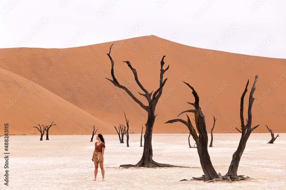 Woman walking around sand dunes in Deadvlei Namibia 