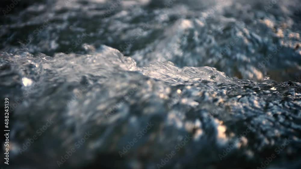 Slow motion of Norwegian mountain river , stream flowing through rocks. Close up of river stones with flowing water, clean water flowing in a mountain river at the Norway