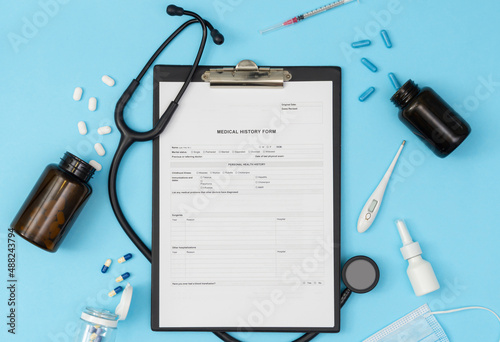 A tablet with a medical history form on a blue background. Medical diagnosis of a doctor's prescription.