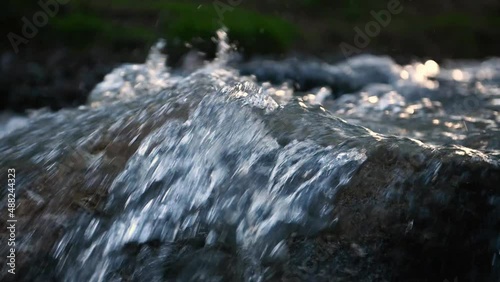 Slow motion of Norwegian mountain river , stream flowing through rocks. Close up of river stones with flowing water, clean water flowing in a mountain river at the Norway