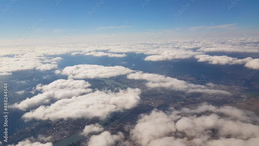 Flying through moving clouds over city landscape Flying through moving clouds over city landscape