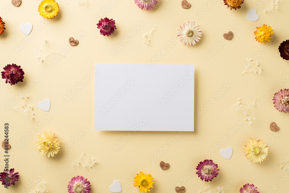 Top view photo of woman's day composition paper card multicolor wild flowers and hearts on isolated beige background with copyspace