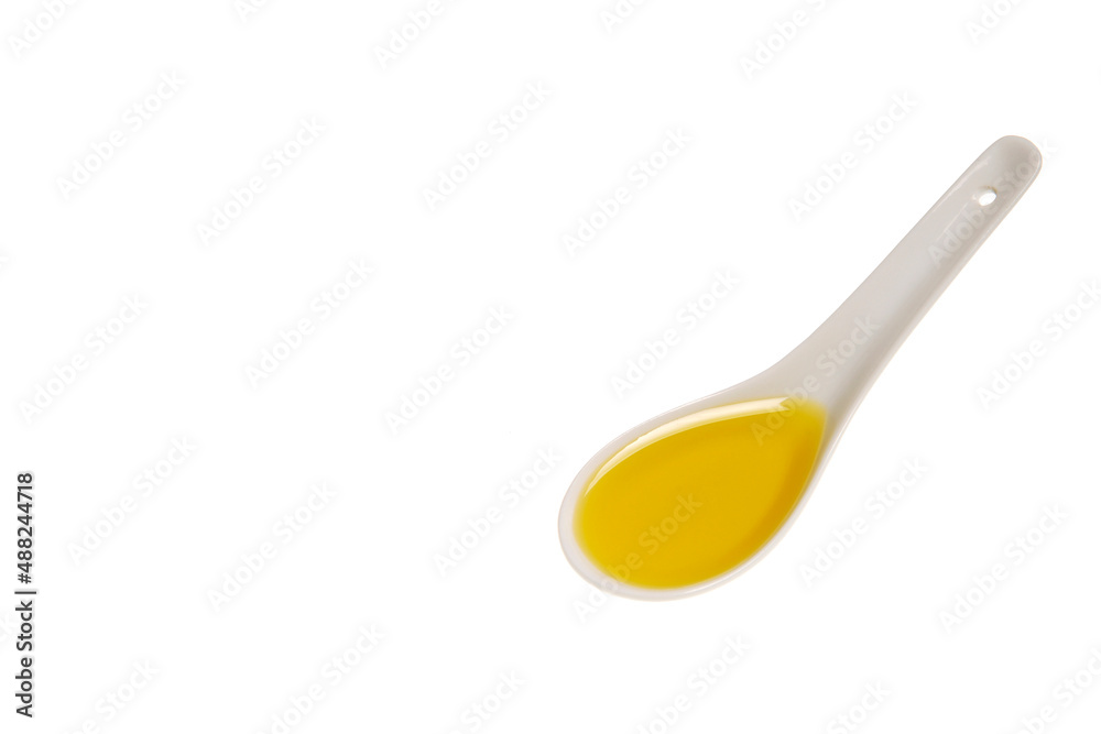 Tablespoon of olive oil, porcelain spoon with olive oil isolated on white background with space Tablespoon of olive oil, porcelain spoon with olive oil isolated on white background with space
