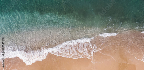 Relaxing aerial beach scene  summer vacation holiday template banner. Waves surf with amazing blue ocean lagoon  sea shore  coastline. Perfect aerial drone top view. Peaceful bright beach  seaside
