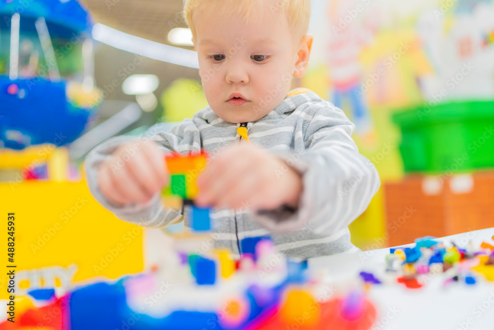 little boy play colorful cubes puzzle at the table little boy play colorful cubes puzzle at the table