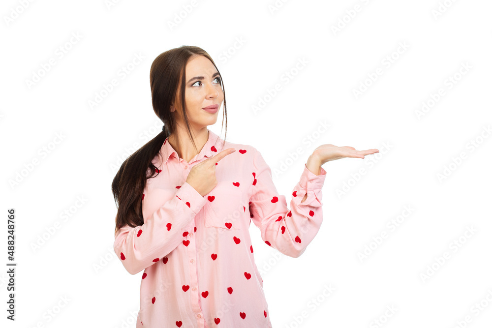 Young, beautiful girl isolated on a white background, points his fingers at the place for promo, offers or advertising. Young, beautiful girl isolated on a white background, points his fingers at the place for promo, offers or advertising.
