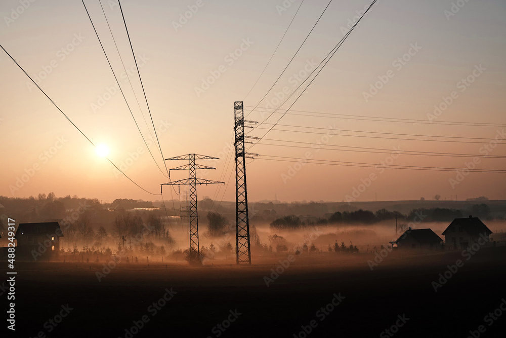 High voltage poles in the morning landscape