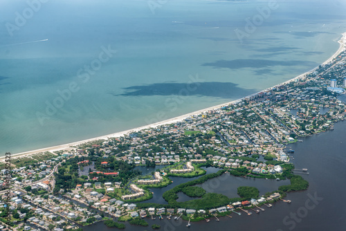 High angle aerial view of Ft Myers beach landscape near Sanibel Island in southwest in Florida Saharan with beautiful green water and houses buildings photo