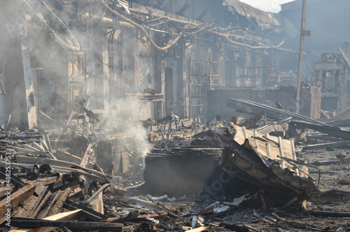 Burnt warehouse in fire. Ruined and damaged building. Burned object in industrial zone. 