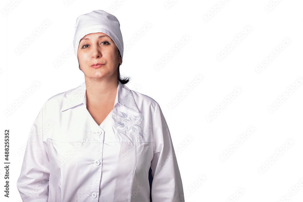 A female doctor in a white uniform smiling on white grey background. A female doctor in a white uniform smiling on white grey background.