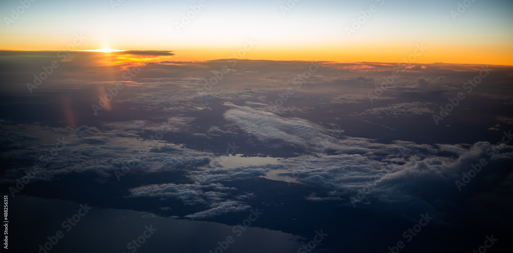 Aerial view from the plane to sunset over the shore Aerial view from the plane to sunset over the shore