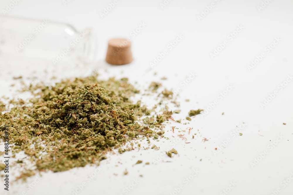 crushed marijuana, with airtight glass container, white background, crushed marijuana, with airtight glass container, white background,