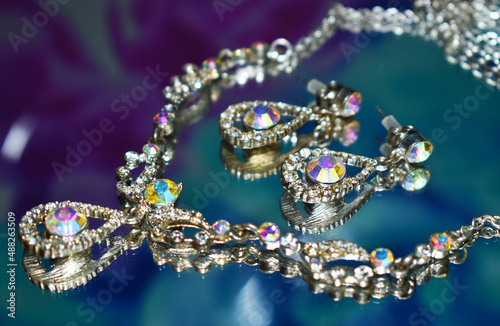 Luxury jewellery diamonds set. Necklace and earrings over mirror