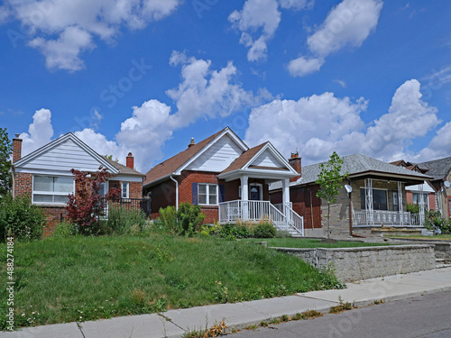 Fototapeta Naklejka Na Ścianę i Meble -  Residential street with small brick bungalows