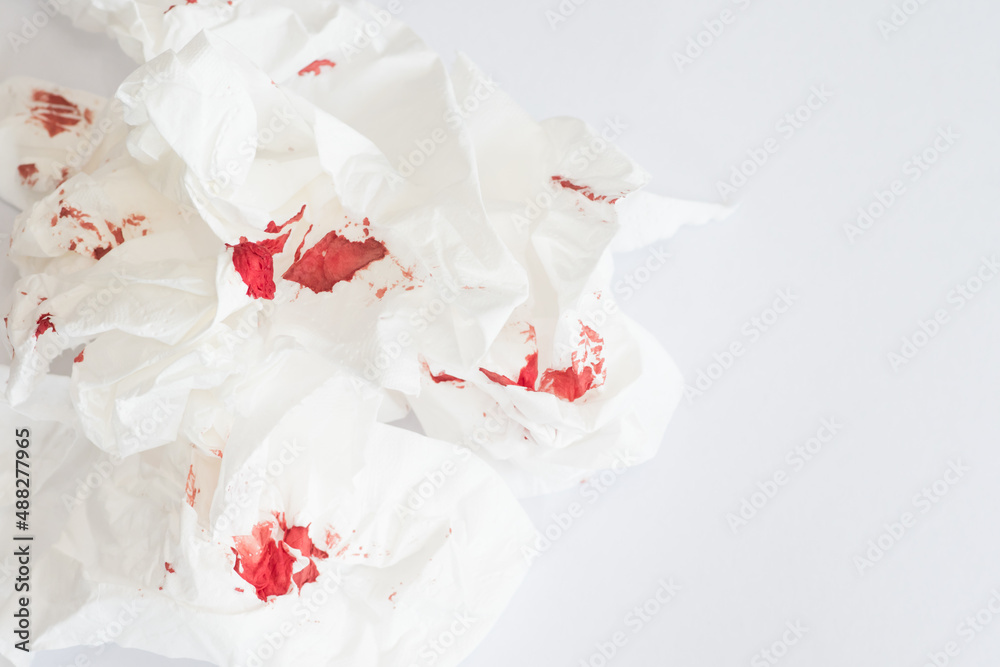 red blood stains on white tissue against white background.