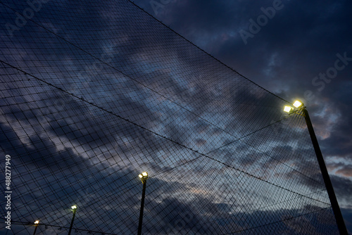 Black sky with football field net background.